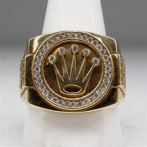 18k gold rolex crown ring.